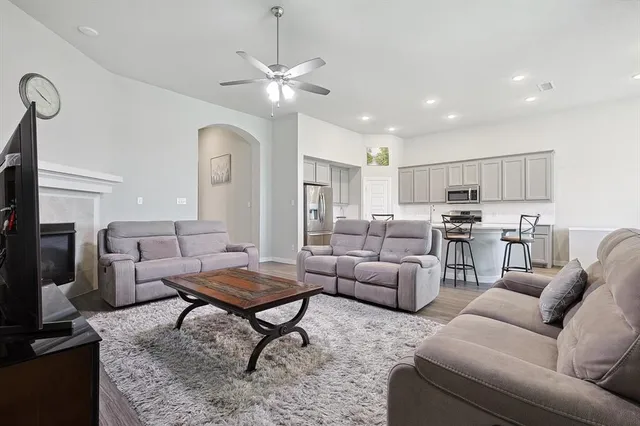 a living room with furniture and kitchen view