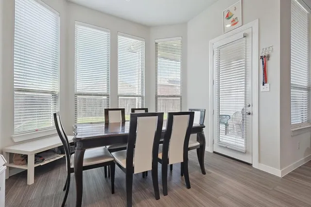 a view of a dining room with furniture and wooden floor