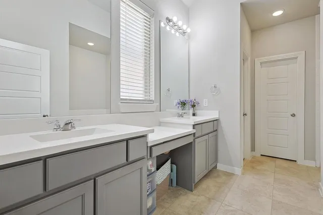 a bathroom with a sink double vanity and a mirror