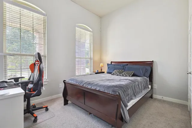 a bedroom with a bed and a desk