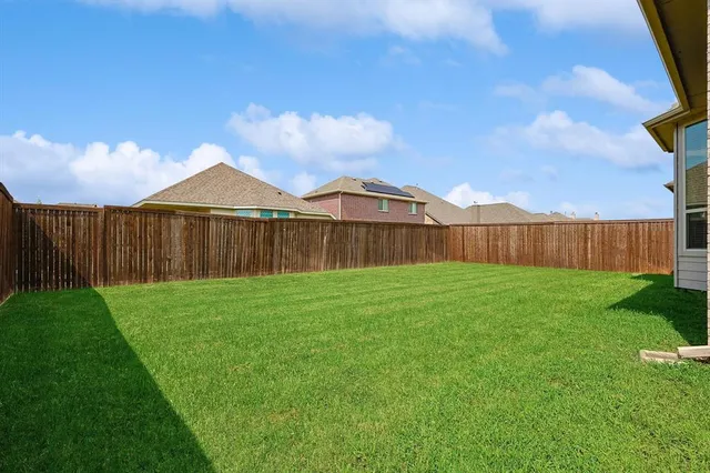 a view of a backyard with table and chairs