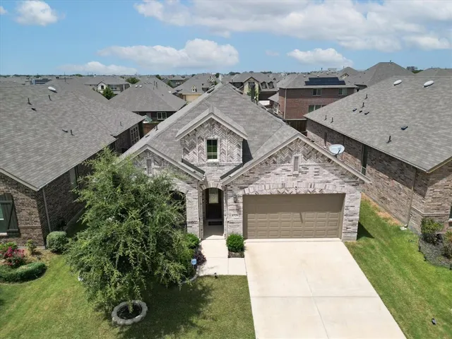 an aerial view of a house with a yard and garage