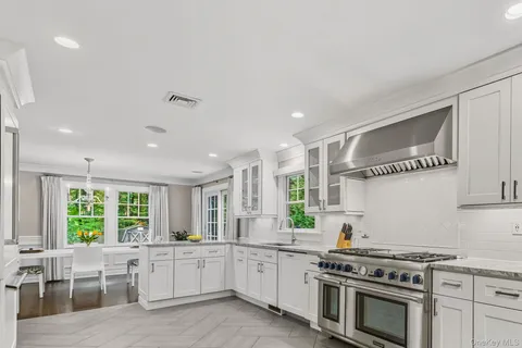 a kitchen with stove a sink and cabinets
