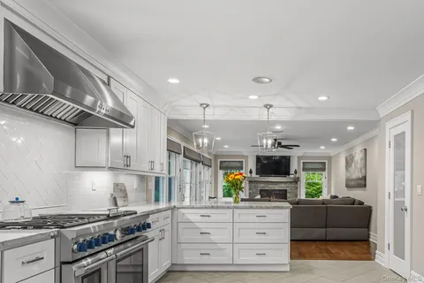 a kitchen with stainless steel appliances granite countertop a stove and a sink