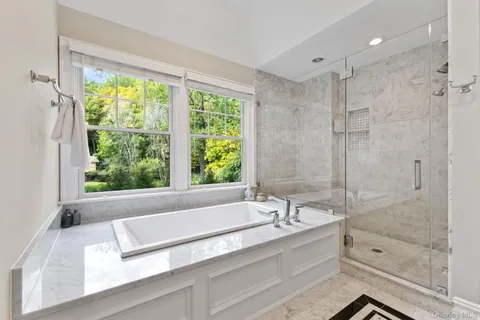 a bathroom with a bathtub and a shower