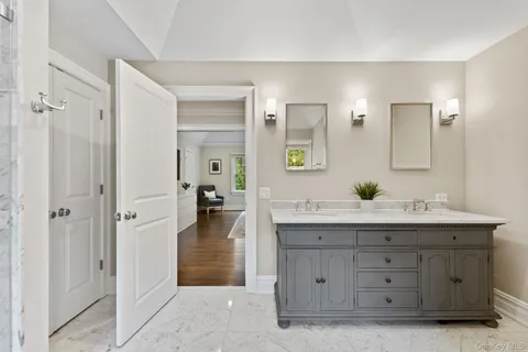 a bathroom with a double vanity sink and mirror