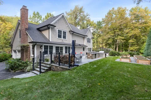 a view of a house with a yard and sitting area
