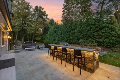 a backyard of a house with wooden floor and outdoor seating