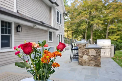 a view of a chairs and table in a back yard of the house