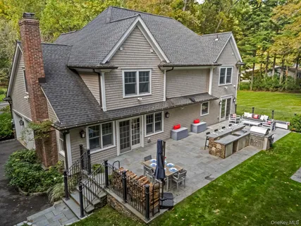 a view of a house with backyard and sitting area