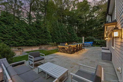 a view of backyard with seating area and trees