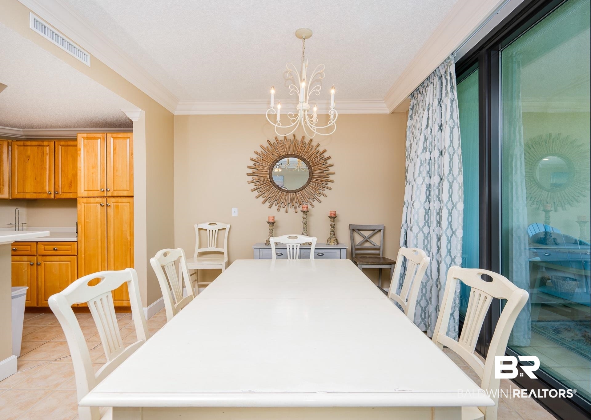 27580 Canal Road, Unit 1429 Orange Beach, AL 36561 - Photo 4 of 45 Dining space with light tile patterned flooring, crown molding, and a chandelier