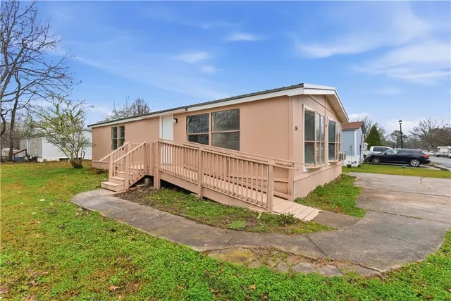 a view of a house with backyard and sitting area
