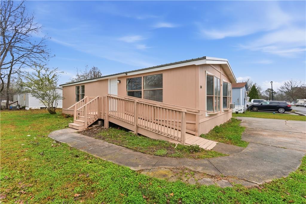 a view of a house with backyard and sitting area