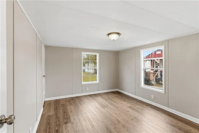 wooden floor in an empty room with a window