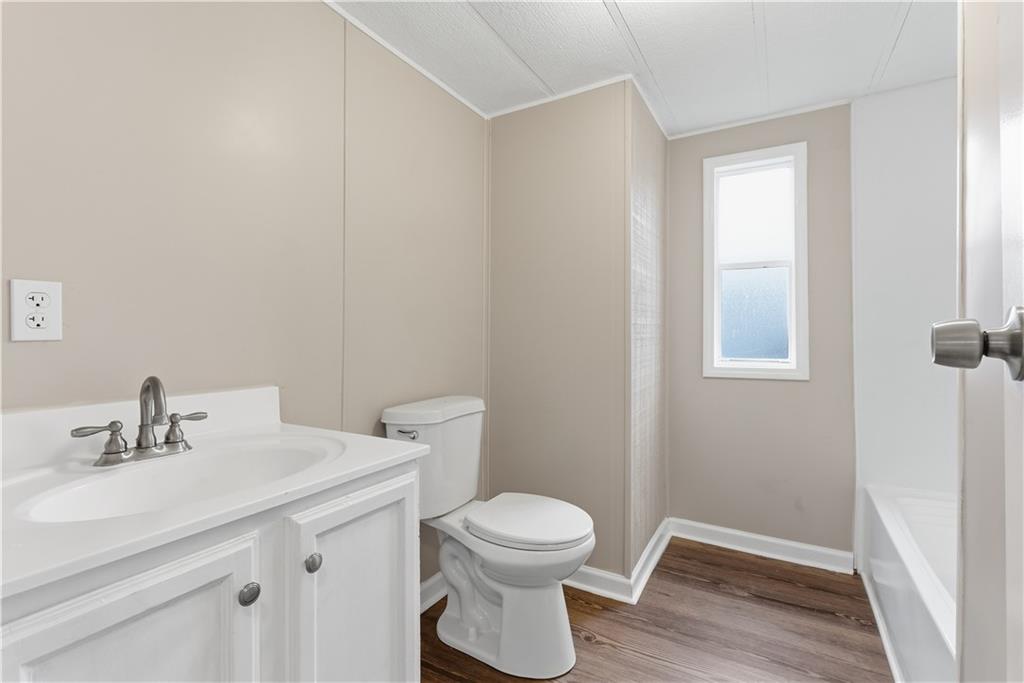 50 Tency Lane Northeast Rome, GA 30165 - Photo 14 of 28 a bathroom with a toilet a sink and mirror