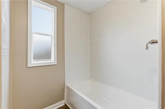 a white bath tub sitting next to a window