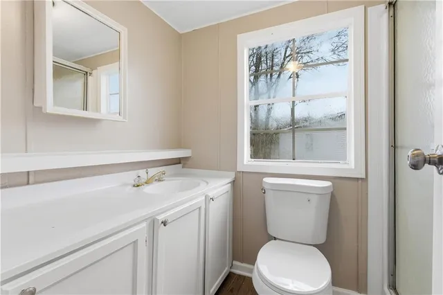 a bathroom with a toilet sink and mirror