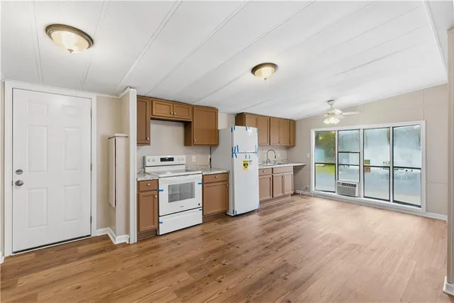 a view of a kitchen with a sink stove and cabinet