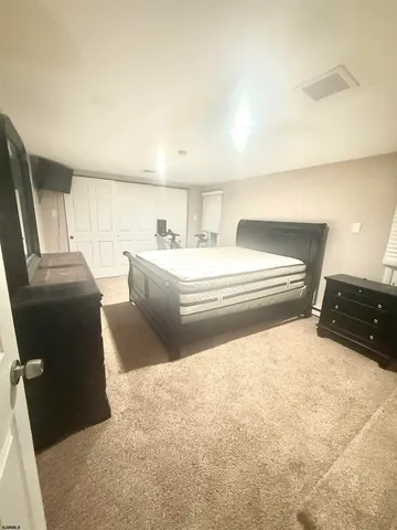 a bedroom with a bed and a television