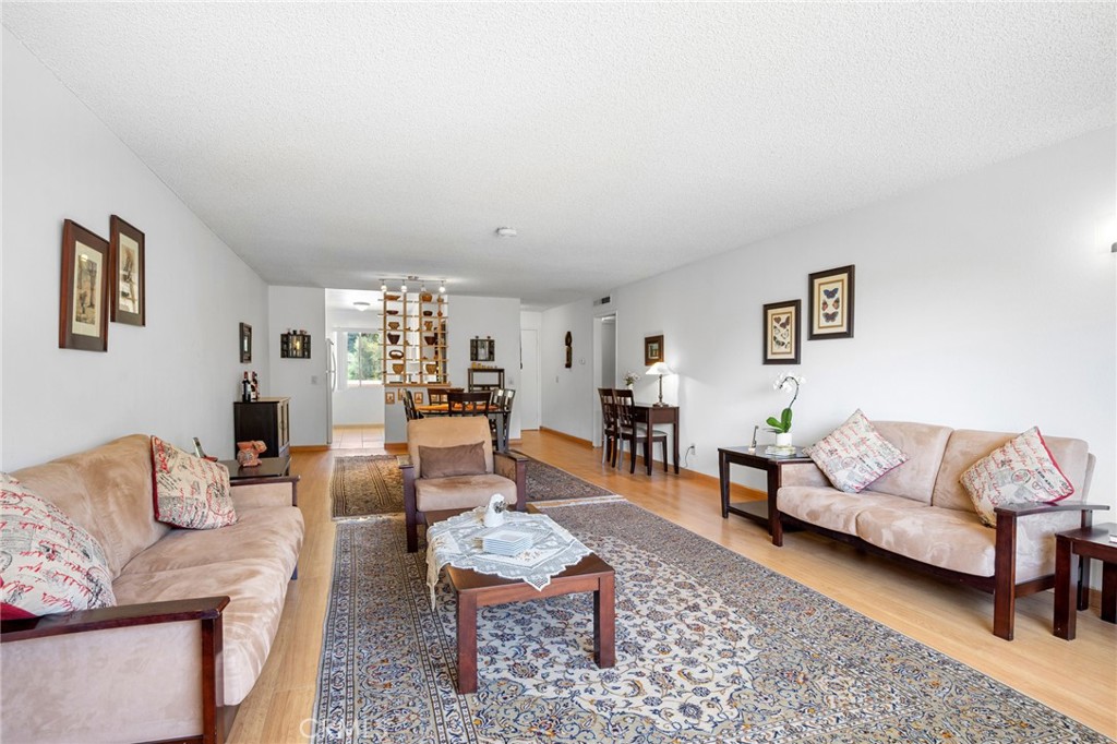 1935 Alpha Road, Unit 214 Glendale, CA 91208 - Photo 10 of 29 a living room with furniture and wooden floor