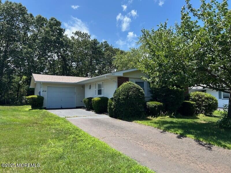 60 Central Boulevard Brick, NJ 08724 - Photo 1 of 22 a front view of a house with a yard and garage