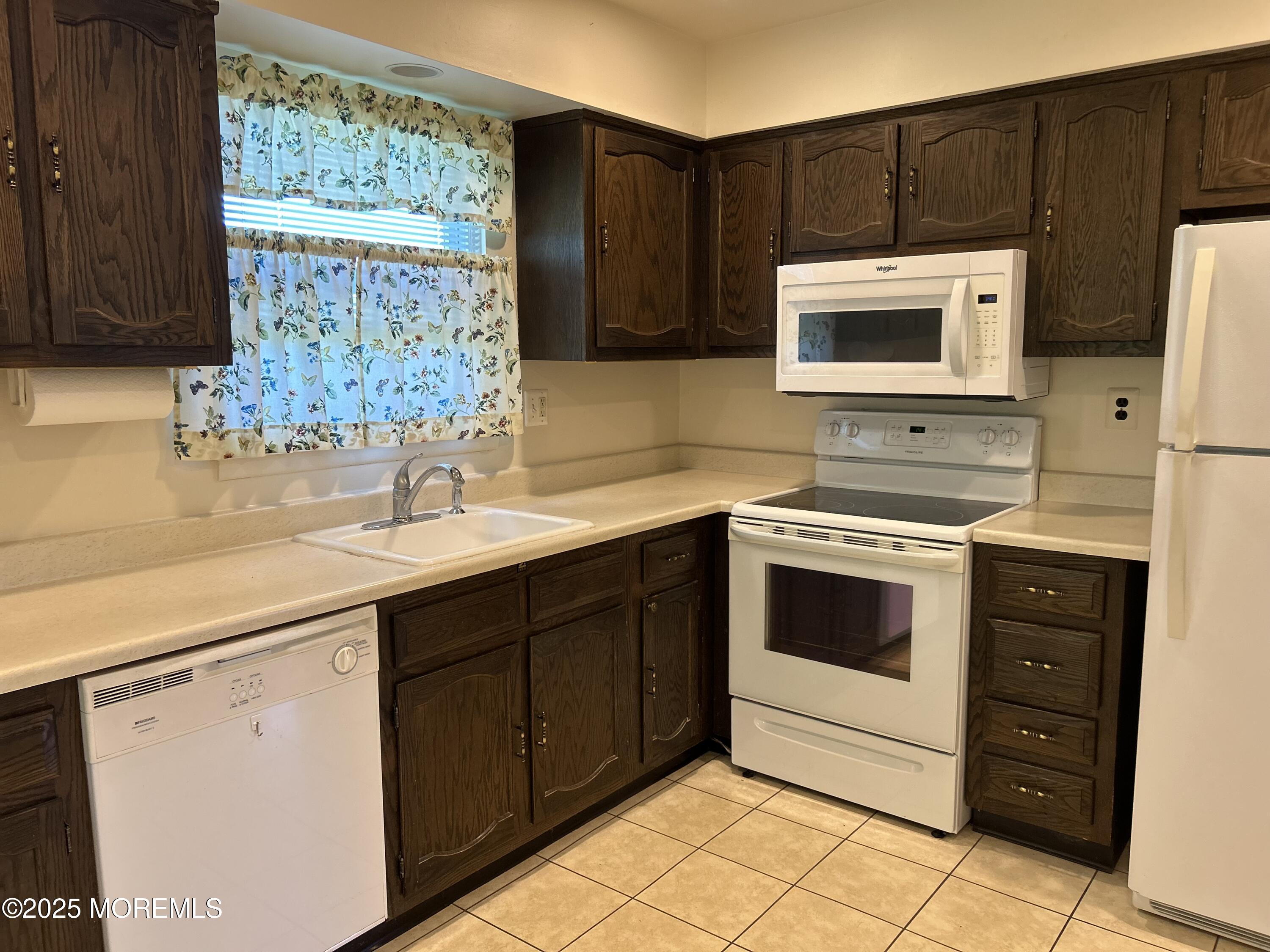 60 Central Boulevard Brick, NJ 08724 - Photo 12 of 22 a kitchen with stainless steel appliances a stove sink and microwave