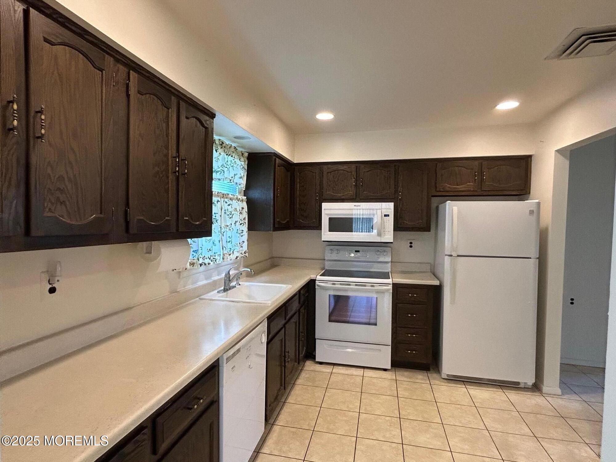 60 Central Boulevard Brick, NJ 08724 - Photo 3 of 22 a kitchen with stainless steel appliances granite countertop a sink stove and refrigerator