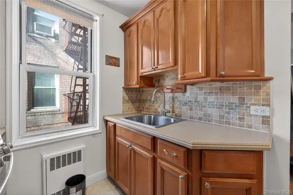 a kitchen with stainless steel appliances granite countertop a sink and a white cabinets