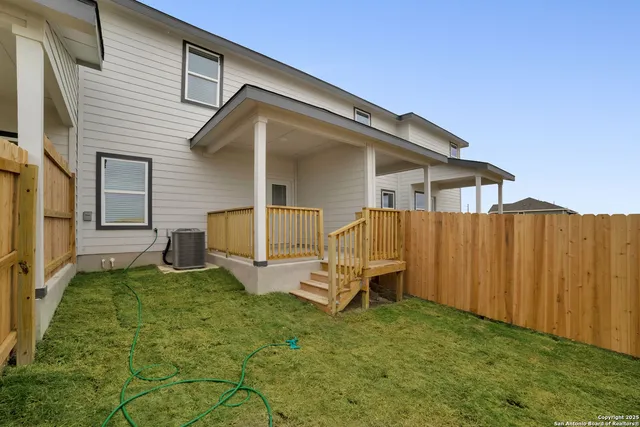 a view of a small house with backyard
