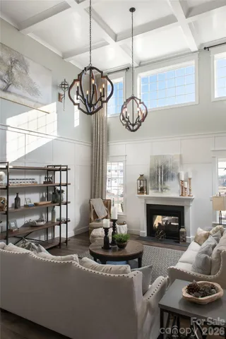 a living room with fireplace furniture and a chandelier
