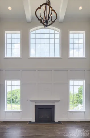 an empty room with windows and balcony