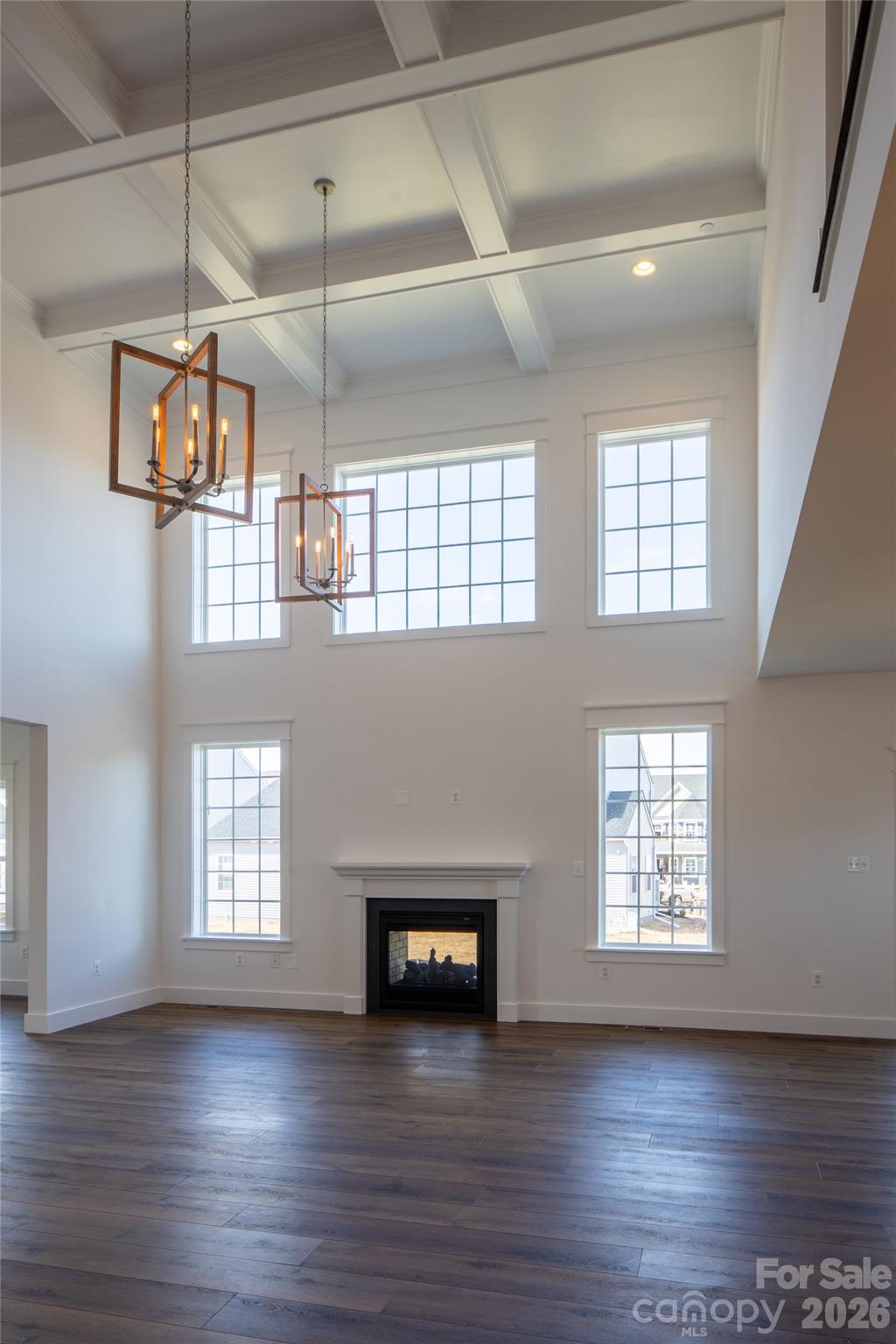 200 Ervin Road, Unit NOTTINGHAM Mooresville, NC 28117 - Photo 16 of 33 a view of a livingroom with wooden floor a ceiling fan and windows