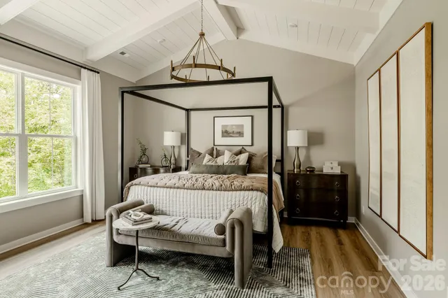a bedroom with a bed and a chandelier