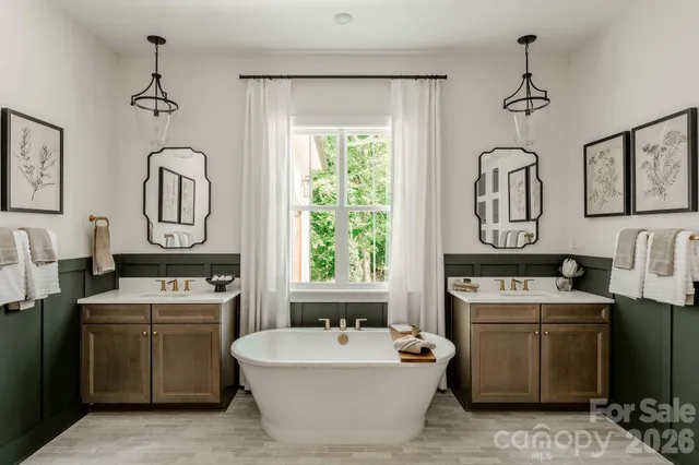 a bathroom with a bathtub sink and mirror