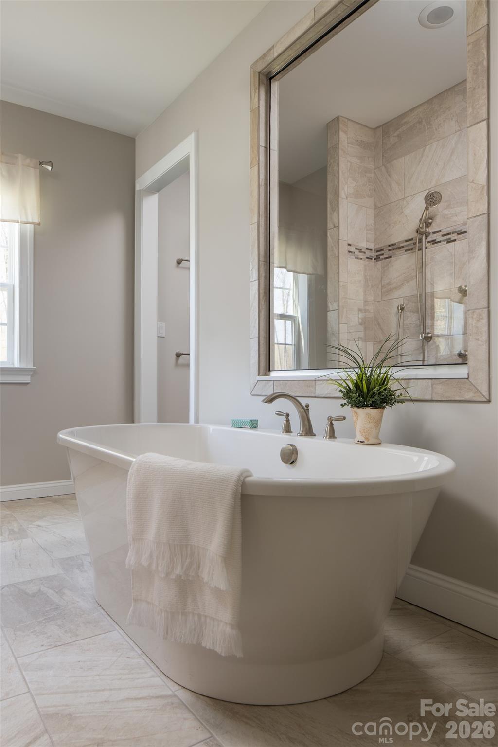 200 Ervin Road, Unit NOTTINGHAM Mooresville, NC 28117 - Photo 27 of 33 a white bath tub sitting in a bathroom