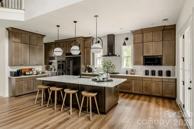a kitchen with stainless steel appliances granite countertop a stove and cabinets