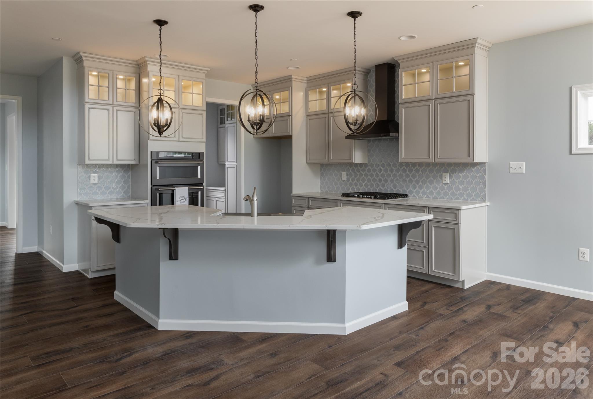 200 Ervin Road, Unit NOTTINGHAM Mooresville, NC 28117 - Photo 10 of 33 a large kitchen with stainless steel appliances granite countertop a stove a sink and a wooden floors