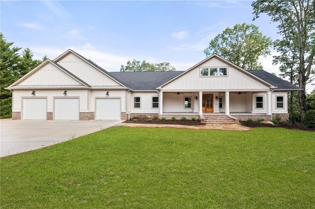0 Arthur Allen Road Cleveland, GA 30528 - Photo 11 of 22 a front view of a house with a garden and porch