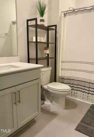 a bathroom with a toilet sink and shower
