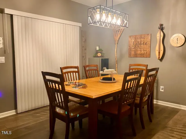 a view of a dining room with furniture and chandelier