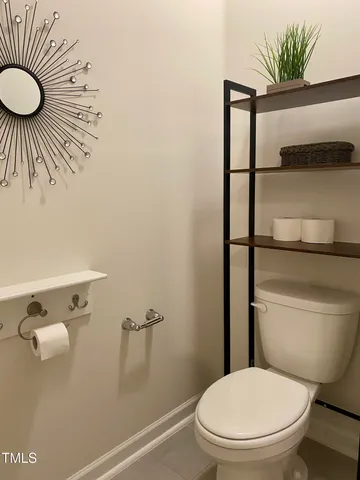 a white toilet sitting next to a shower