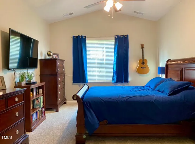a bedroom with a bed and flat screen tv