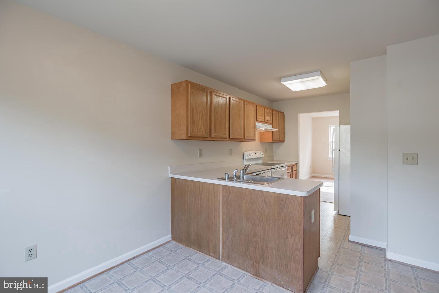 8549 E Street Chesapeake Beach, MD 20732 - Photo 6 of 10 a kitchen with a sink a cabinets and window