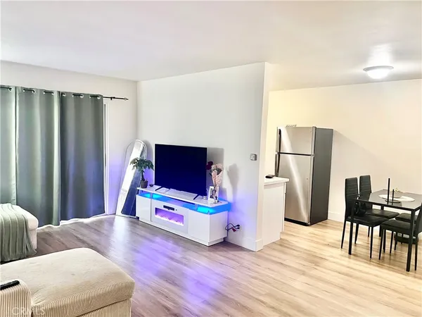 a living room with furniture wooden floor and a flat screen tv