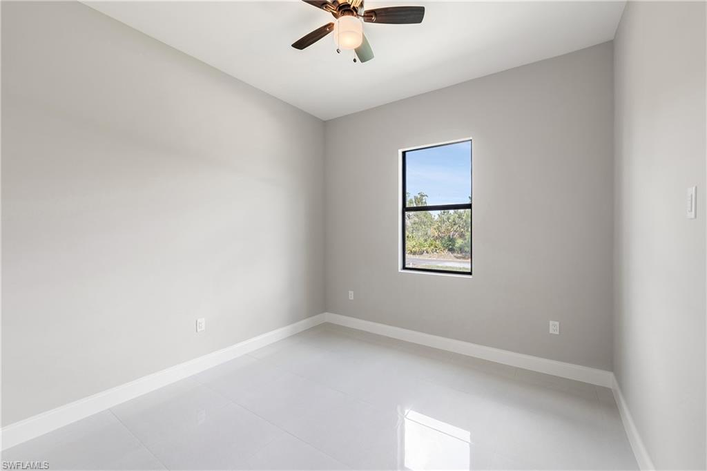 2903 37th Street West Lehigh Acres, FL 33971 - Photo 13 of 23 an empty room with a window and a ceiling fan