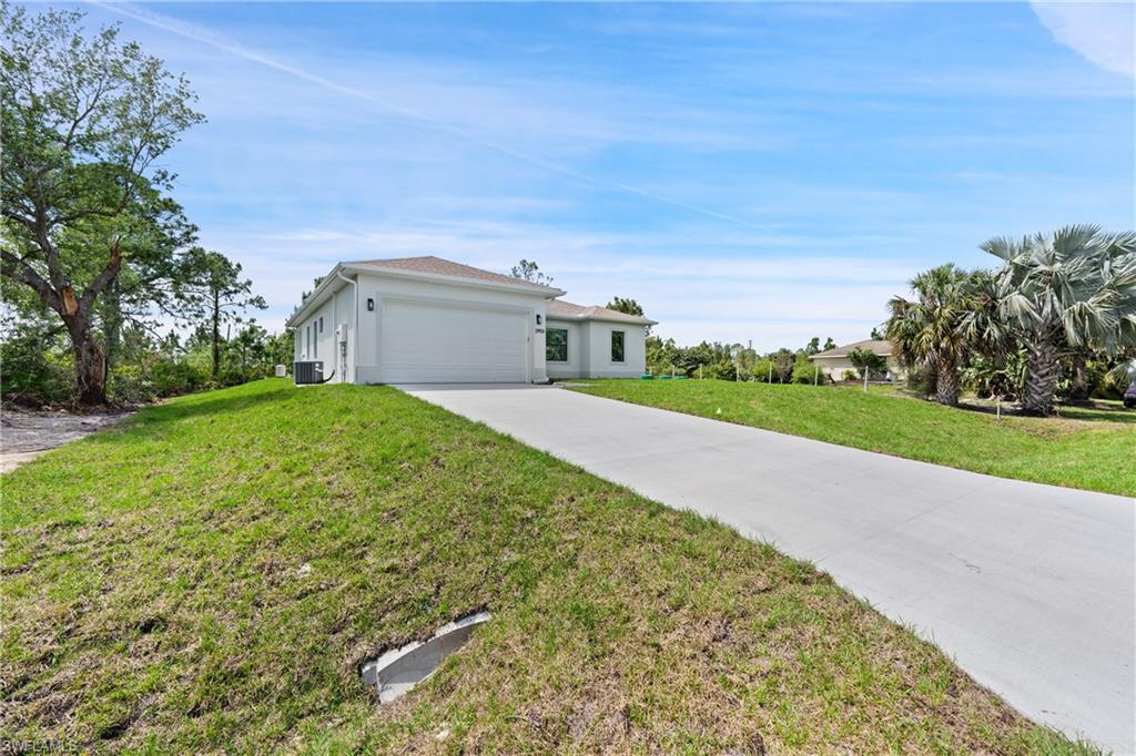2903 37th Street West Lehigh Acres, FL 33971 - Photo 16 of 23 a view of a house with a yard and pathway