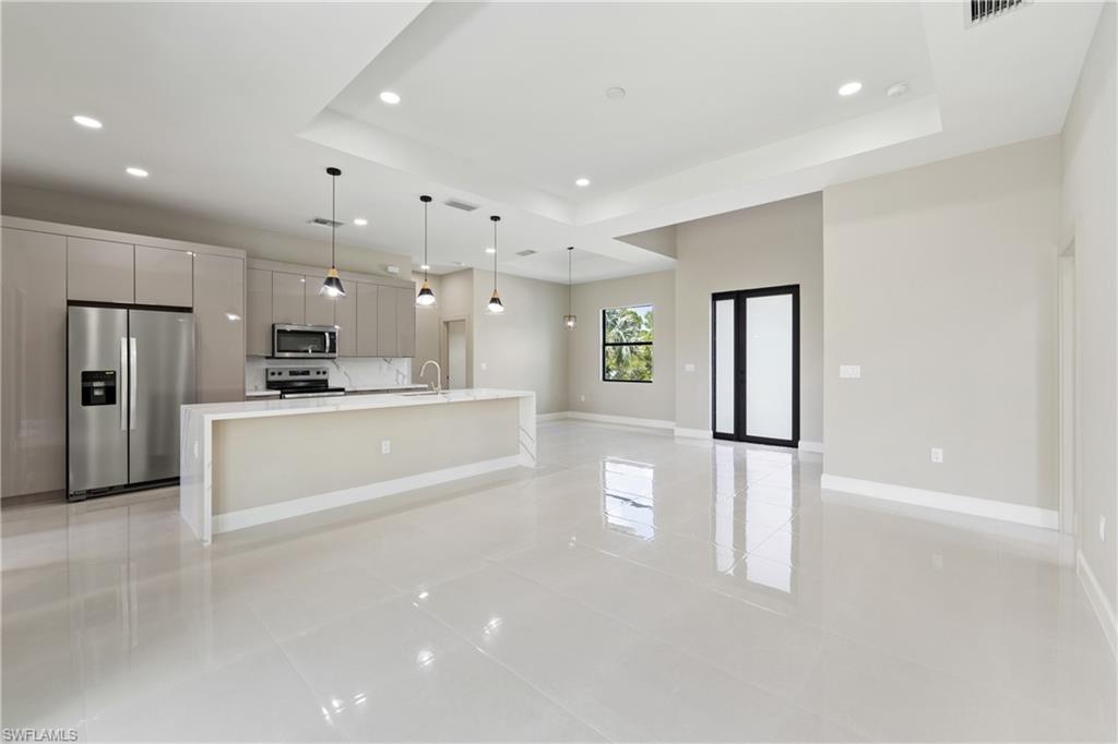 2903 37th Street West Lehigh Acres, FL 33971 - Photo 2 of 23 a large white kitchen with refrigerator a sink and a dishwasher