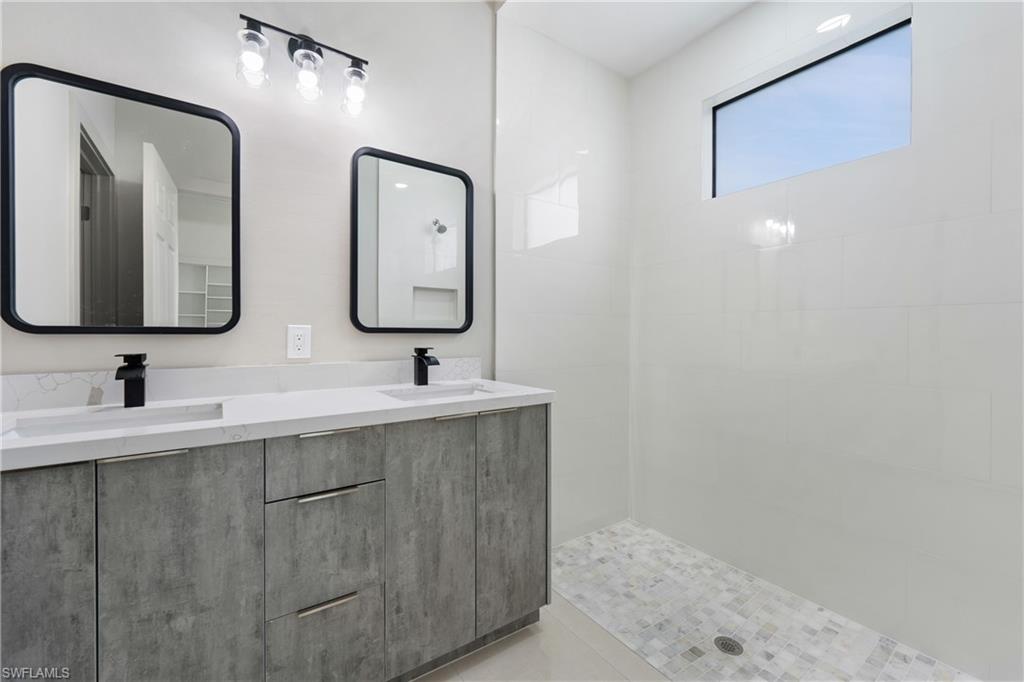 2903 37th Street West Lehigh Acres, FL 33971 - Photo 4 of 23 a bathroom with 2 sink and a mirror