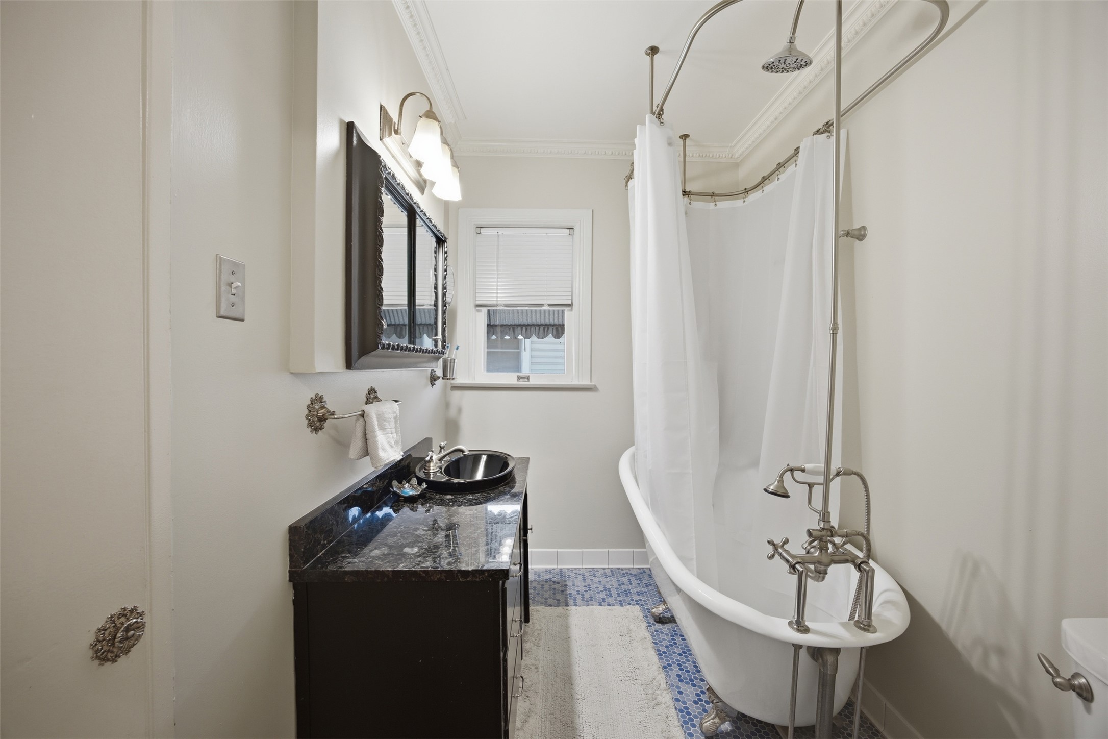 1030 East 44th Street Austin, TX 78751 - Photo 12 of 29 a bathroom with a sink a toilet and mirror